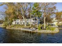 A beautiful waterfront home featuring a private dock and ample outdoor entertaining space at 7780 Paw Paw Dr, Nineveh, IN 46164