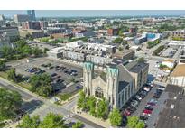 Aerial view showcasing the building, its proximity to parking, and surrounding cityscape at 802 N Meridian St # 204, Indianapolis, IN 46204