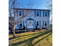 Charming two-story home with blue shutters, a decorative door, and a landscaped front yard at 8271 Shattuck Dr, Avon, IN 46123