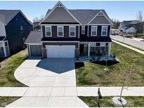 Beautiful two-story home with a well-maintained lawn and a spacious driveway at 8729 Dorill Creek Ln, Indianapolis, IN 46259