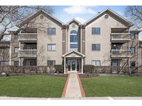 Inviting exterior view of a multi-story condo building with balconies, well-maintained landscaping, and clearly marked address at 8820 Yardley Ct # 101, Indianapolis, IN 46268