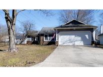 Charming single-story home with a two-car garage, complemented by a well-maintained front yard at 9161 Warwick Rd, Indianapolis, IN 46240