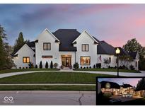 Stunning two-story white brick home with manicured lawn and professional landscaping at 10351 Windemere Blvd, Carmel, IN 46032