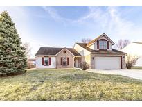 Charming two-story home featuring brick and vinyl siding, attached garage and landscaped front yard at 10893 Cannonade Ct, Indianapolis, IN 46234