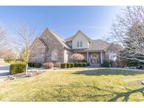 Charming two-story brick home with a welcoming front porch and well-maintained lawn at 1115 Morningside Ct, Greenfield, IN 46140