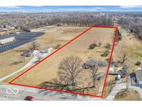 Expansive land parcel outlined in red, featuring grassy fields and scattered trees at 1229 N German Church Rd, Indianapolis, IN 46229