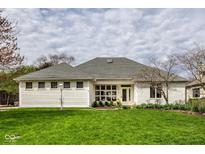 Charming single story home with tidy lawn, white siding and a cozy entryway at 12526 Pembrooke Cir, Carmel, IN 46032