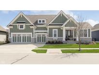 Craftsman home featuring an attached garage and covered entry on a lush green lot at 1499 Avondale Dr, Westfield, IN 46074