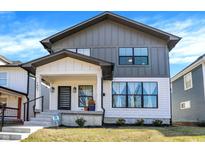 Charming two-story home featuring a modern design, covered front porch, and gray and white color scheme at 1603 Nowland Ave, Indianapolis, IN 46201