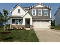 Charming two-story home featuring a two-car garage, brick accents, and well-manicured lawn, offering curb appeal at 2218 Boxwood Dr, Greenfield, IN 46140