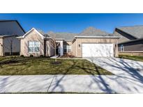 Inviting single-story home featuring a brick facade, attached two-car garage, and well-maintained lawn at 2352 Somerset Cir, Franklin, IN 46131