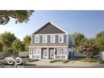 Charming blue two-story home featuring a covered front porch and classic architectural design at 2833 Macpherson Ave, Indianapolis, IN 46205