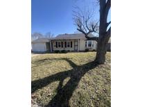 Well-maintained single-story home with an attached garage and a mature tree at 3531 Welch Dr, Indianapolis, IN 46224