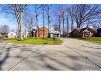 Charming red brick home with a two-car garage situated on a well-manicured lawn at 449 Old Hickory Ln, Greenwood, IN 46142