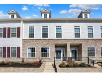 Charming townhome with stone accents, dormer windows, and well-maintained landscaping at 656 Lagerfield Dr, Carmel, IN 46032
