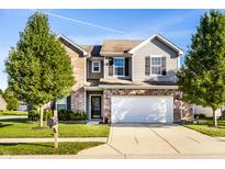 Charming two-story home featuring mixed brick and vinyl siding and a well-manicured front lawn at 948 Northwich Ave, Westfield, IN 46074