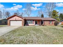 Charming single-story home with a brick facade, attached garage, and well-maintained lawn at 12 Danridge Dr, Danville, IN 46122