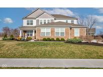 Charming two-story home with a well-maintained lawn and landscaping at 12073 Springtide Ln, Fishers, IN 46037