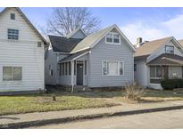 Charming home with a light gray exterior, featuring a screened porch at 1211 W 30Th St, Indianapolis, IN 46208