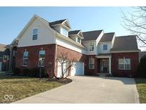 Beautiful two-story brick and vinyl home featuring an attached two-car garage and well-manicured lawn at 12387 Wolverton Way, Fishers, IN 46037