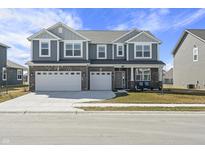 Beautiful two-story home featuring a two-car garage, brick accents, and neutral gray siding at 1399 Hat Band St, Danville, IN 46122