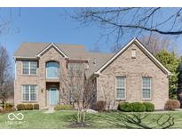 Traditional brick two-story home with well-maintained landscaping, mature trees, and covered entryway at 14870 Starboard Rd, Fishers, IN 46040