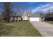 Charming brick home featuring a two-car garage and well-manicured front yard at 154 Dover N Blvd, Brownsburg, IN 46112