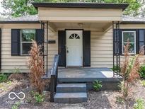 Inviting front door with decorative glass and cozy covered porch featuring black accents and charming curb appeal at 1707 N Leland Ave, Indianapolis, IN 46218