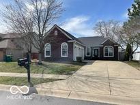 Charming brick home with an attached two car garage and long driveway at 1808 Turning Leaf Dr, Franklin, IN 46131