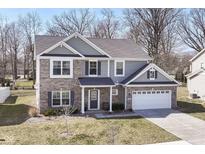 Charming two-story home featuring a brick facade, gray siding, and an attached two-car garage at 192 Lynnette Way, Indianapolis, IN 46229