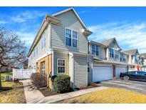 Two-story home with light siding, brick accents, attached garage and driveway at 2255 Colfax Ln, Indianapolis, IN 46260