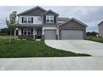 Charming two-story home with a two-car garage, manicured lawn, and a welcoming front entrance at 2290 Oakmont Dr, Plainfield, IN 46168