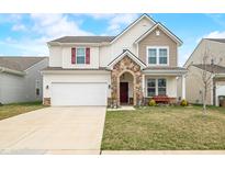 Charming two-story home featuring mixed siding, stone-accented entryway, and well-manicured lawn at 2586 Creek Bank Dr, Columbus, IN 47201