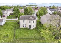 Aerial view of home featuring a spacious backyard with well-kept lawn and black metal fence at 2992 Sentiment Ln, Greenwood, IN 46143