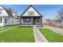 Charming two-story home with freshly cut lawn and traditional design elements at 3324 E Vermont St, Indianapolis, IN 46201