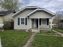 Modest single-Gathering home featuring a small front porch and dark green shutters at 335 S Dearborn St, Indianapolis, IN 46201
