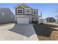 Charming two-story home featuring a covered front porch and an attached two-car garage at 3719 Lexham Ct, Danville, IN 46122