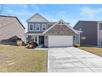 Charming two-story home featuring a brick-accented facade, gray siding, and a well-manicured front lawn at 4337 Blue Note Dr, Indianapolis, IN 46239