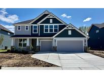 Charming two-story home showcasing a spacious two-car garage and a beautifully designed exterior at 8445 Morgan Ln, Zionsville, IN 46077