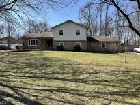 Charming two-story home with stone accents and a spacious front yard at 8811 Saville Rd, Noblesville, IN 46060