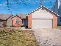 Charming single-story home featuring a brick facade, two-car garage, and well-manicured lawn at 1032 Rotherham Ln, Beech Grove, IN 46107
