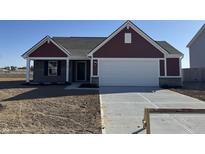 A charming home with a two-car garage, red siding, and a well-manicured lawn, ready for new owners at 1195 Andromeda Dr, Franklin, IN 46131