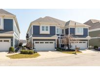 Beautifully maintained multi-story home featuring a three-car garage and attractive blue siding at 12561 Marina View Dr, Indianapolis, IN 46256