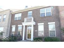 Charming brick townhome with inviting front entrance and balcony detail at 13499 Molique Blvd, Fishers, IN 46037