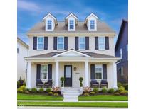 Charming two-story home featuring a welcoming front porch, black shutters, and dormer windows at 15304 Fairlands Dr, Westfield, IN 46074