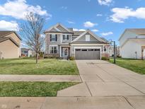 Beautiful two story home featuring a well maintained lawn, driveway, and a two-car garage at 15965 Falcons Fire Dr, Westfield, IN 46074