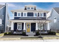 Charming two-story home with a welcoming front porch, classic columns, and a bright yellow front door at 1671 Avondale Dr, Westfield, IN 46074