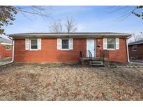 Charming red brick home with white trim and a neatly landscaped front yard at 4013 Priscilla Ave, Indianapolis, IN 46226