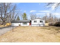 Charming one-story home with manicured front lawn and attached two car garage at 5118 E 69Th St, Indianapolis, IN 46220