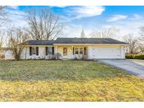 Charming single-story home with a manicured lawn and an attached two-car garage at 515 N Odell St, Brownsburg, IN 46112